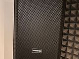 a speaker that is sitting on a stand in a room