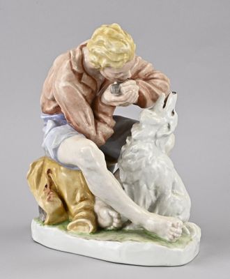 figurine of a man feeding a dog on a plate