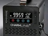 an alarm clock sitting on top of a black table next to a charger