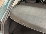 the back of a car with the trunk door open and the seat folded down