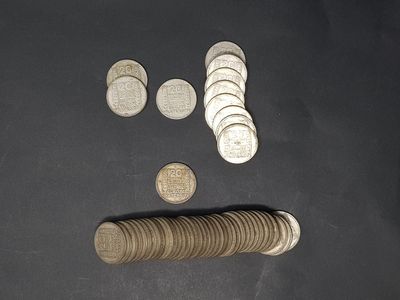 a pile of coins and a roll of coins on a table
