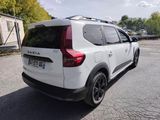 the back end of a white suv parked in a parking lot