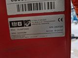 a close up of a red machine with a barcode on it