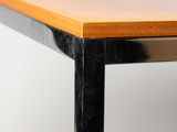 a close up of a wooden table with black metal legs