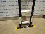a close up of a ladder in a warehouse with a sign in the background