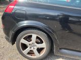 a black car that is parked on the side of the road