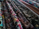 many different types of fabric on display in a store