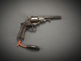 an old gun with an orange cord attached to it