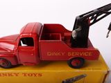 a red toy truck with a crane on top of it