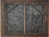 an old window with a wooden frame on the wall