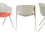 three chairs with a red seat and a white one and a gray one