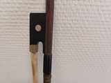 a wooden stick and a wooden stick holder on a white surface