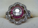 an image of a diamond and ruby ring