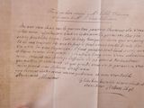 a hand holding a piece of paper with writing on it