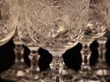 several empty wine glasses are lined up on a table