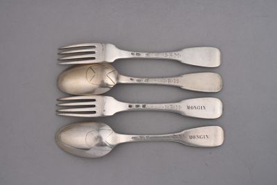 four forks and spoons are lined up on a gray surface