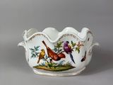 a white bowl with birds and flowers painted on it