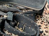 a black purse with a leopard print pattern on it