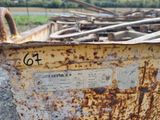 a rusted metal container with a number on it