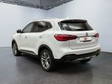 the rear end of a white suv parked in a garage