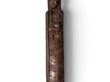 an old wooden carving of a woman with a headdress