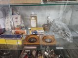 a glass display case filled with silverware and other items