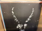 the album is being held up by a person with a goat head on it