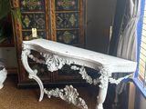 a white table with a mirror on it in a room