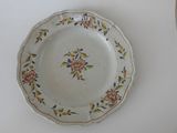 a plate with a floral design on it on a table
