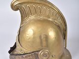 brass helmet on a white surface with a white background