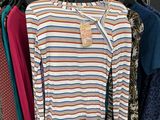 a rack of clothes hanging on a clothes rack in a store