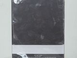 the back of a package of black cloth sitting on top of a white table