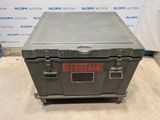 a metal box sitting on top of a cement floor next to a wall