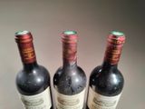 three bottles of wine sitting next to each other on a table
