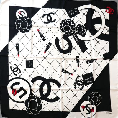 a black and white scarf with a picture of a chanel logo on it