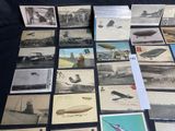 a lot of old photos of airplanes on the table