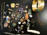 many different types of jewelry on a black table