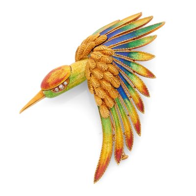 une image représentant une broche en forme d'oiseau coloré sur fond blanc