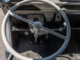 a steering wheel and dashboard of a car in a parking lot