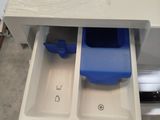 a drawer that has a blue plastic container in it