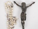 a rosary and a statue of jesus on a white background