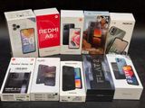 several boxes of various cell phones sitting on top of a table