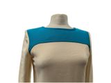 the back of a woman ' s dress with a blue and beige color block