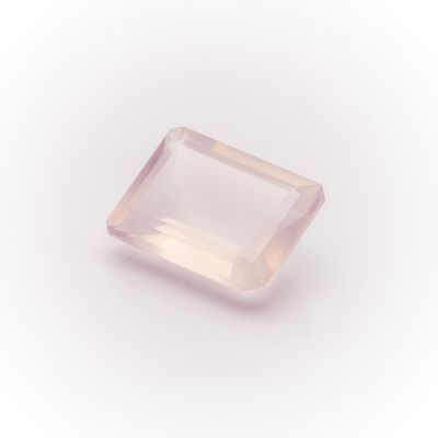 a pink quartz stone on a white background