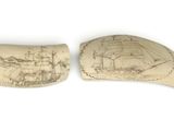 two pieces of ivory with a drawing of a ship on it