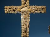 a statue of jesus on a cross made out of wood
