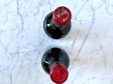 two bottles of wine sitting on a marble table