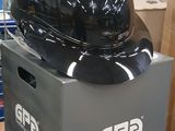a helmet sitting on top of a box in a warehouse
