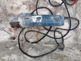 a drill on the ground with a cord attached to it
