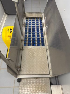 a metal door with blue tiles on it in a room